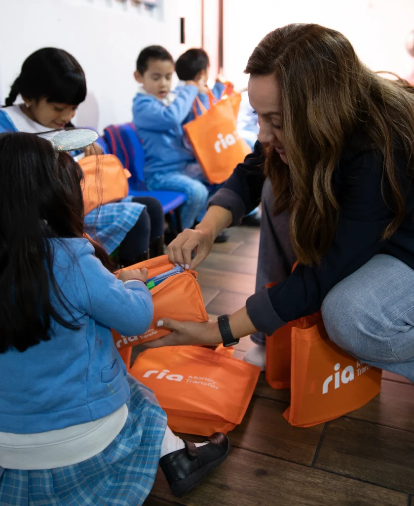 Children with orange Ria bags